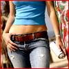 A cropped image shows a person wearing a blue crop top and light blue jeans with a brown belt, holding a white object in one hand.