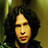 Pixelated close-up of a person with dark curly hair against a gradient background, featuring warm yellow and brown tones.