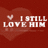 Red background with heart shape, white text "I STILL LOVE HIM" and small heart symbol above text.