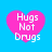 Four pink heart-shaped icons with white text "Hugs Not Drugs" on a blue background, arranged in a