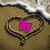 A heart drawn in sand with text inside, showing three states: pink 'ily', blue 'zach', and a pink heart symbol.