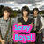Three people stand together outdoors holding a bright pink sign with blue text reading 'Sexy Boys!!' against a blurred background.