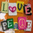 Pixelated collage of six distinct letter-shaped icons arranged in two rows on a warm orange-brown background, each with unique color schemes and internal designs.