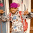 Pixelated image of a person with purple headwear and red accents, standing beside text reading 'chris is my rock star' in pink block letters.