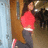 Pixelated image of a person in red top and dark pants with blue text elements on black background.