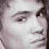 Pixelated close-up of a person's face showing eyes, nose, and mouth with light skin tones against dark hair background.