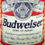 Static pixelated icon of a Budweiser beer can with red and white branding, blue text, and a silver cap on top.