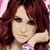 Two side-by-side pixelated images of a woman with long red hair, one showing her resting hand on cheek and the other with heart-shaped highlights in hair.