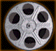 Four circular film reels with dark oval perforations arranged in a , each reel showing distinct rotation states against black backgrounds