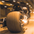 A pixelated image of a large brown spherical object with a bright white spot on its right side, set against a blurred background of brown and orange tones.