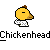 Pixelated yellow chicken head with brown comb and beak, wearing white checkered shirt on gray background.