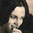 Static 48x48 pixel icon showing a close-up of a person's face with dark hair against a dark background, rendered in low-resolution grayscale tones.