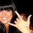 A four- shows a person in graduation attire making hand gestures and smiling, with one missing content