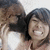 Two people in a close-up pose with one person's arm around the other, smiling broadly in a pixelated image.