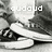 Pixelated grayscale image of a stylized figure with text 'audou' and partial 'in' visible, rendered in low-resolution digital art style.