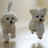 Two pixelated dog icons with brown fur, black eyes and noses, standing upright on a light beige background.