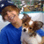A person in a blue shirt holds a brown and white dog, with the dog's head turning slightly left to right across frames.