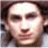 Pixelated close-up of a person's face with light skin tone, dark hair, and neutral expression, cropped to show forehead to chin.
