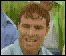A pixelated animated sequence shows a person in a light blue shirt against green and blue background, with changing facial expressions from smiling to open-mouthed laughter.