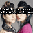 Two women in pink tops and black lace necklaces pose closely together against a gray background, with visible text overlays.