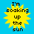 Four identical yellow sun icons with black text "I'm soaking up the sun" on a solid blue background, arranged in a