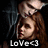 Pixelated image of a person with brown hair and light skin, wearing dark clothing against black background with white text "Love" at bottom.