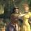 Animated sequence showing two figures in a forest setting, one figure in yellow dress embracing another in brown top and purple pants