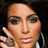 A person with dark hair and large hoop earrings holds a hand near their face, showing a ring on the ring finger.