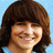 A pixelated image of a person with brown hair against a blue background, next to the word "LOVE" in alternating blue and pink letters on white.