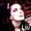 Animated pixelated image of a person with dark hair and light skin, wearing a black top, against a dark background.