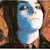 Animated sequence showing a blue-skinned character with white face paint and red lips, followed by a close-up of red lips with the word 'Vampire' and a woman with long curly hair.