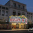 Pixelated image of a building facade with a large colorful sign displaying 'FOX' in pink letters above a yellow section.