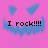 Pixelated pink background with blue triangular eyes and jagged mouth, displaying 'I rock!!!!' text in black pixel font.