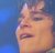 Pixelated close-up of a person's face with closed eyes, showing partial features against a blue background.