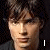 A pixelated image of a person with brown hair and dark clothing, featuring text elements 'I', 'Love', 'Tom', 'Welling', and a red heart symbol.