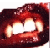 Static pixelated image of a mouth with sharp teeth and red gums, rendered in dark reds and whites on a white background.