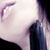 Pixelated close-up of a person's face showing eye, nose, and mouth with dark clothing against light background.