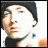 Pixelated static image of a person's face in profile view with dark hair and light skin tones, rendered at low resolution on a white background.