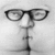 A split-frame contact sheet showing a grayscale face with glasses on the left and yellow text reading "KISS THIS FACE!" on a black background on the right.