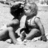 Black-and-white pixelated image of two people embracing on a beach with text "Love at first sight" and a heart symbol below.