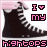 Pixelated image of black high-top sneakers with white laces and pink accents, featuring text elements and a repeating pattern.