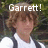 Pixelated image of a person with brown hair wearing a white shirt and dark tie, overlaid with large white text reading "Garrett!" against a blurred green background.
