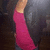 A pixelated static image shows a person in a long pink dress with light skin and dark hair against a blurred background.