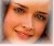 Pixelated close-up of a person's face showing eyes, nose, mouth with lips slightly parted and visible teeth.