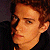 Pixelated image of a person with brown hair and dark clothing on the left, next to green text reading 'Original Icons .com' on a solid green background.