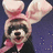 Pixelated image of a dog wearing pink bunny ears and a pink scarf, with text elements in bright pink on black and gray backgrounds.
