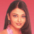 Pixelated close-up of a person with long dark hair against a solid pink background, wearing a light-colored top.
