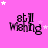 Pink background with white stars and black text reading 'still Wishing' in a pixelated font, arranged in three of four