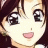 Anime-style character face with brown hair and large eyes, next to pixelated text on a black background.