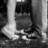 Black-and-white pixelated image of two figures standing side-by-side with text "Damn" in the upper right corner.